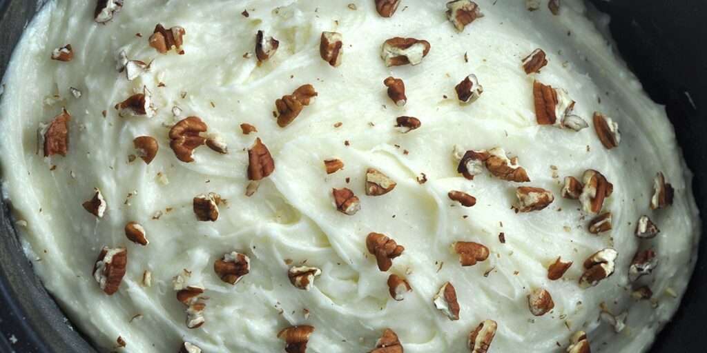 It's August and around here that means we have an abundance of zucchini. So, that means it is time for our family's absolutely favorite crock pot zucchini recipe from childhood: a sweet, super moist cake-like dessert with an incredible thick cream cheese icing.